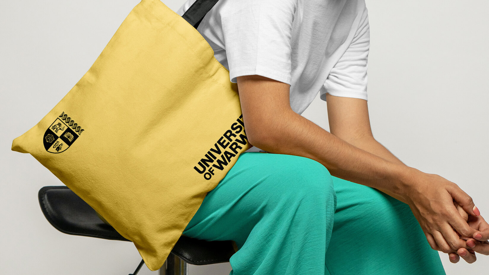 A yellow tote back with University of Warwick crest and wordmark.