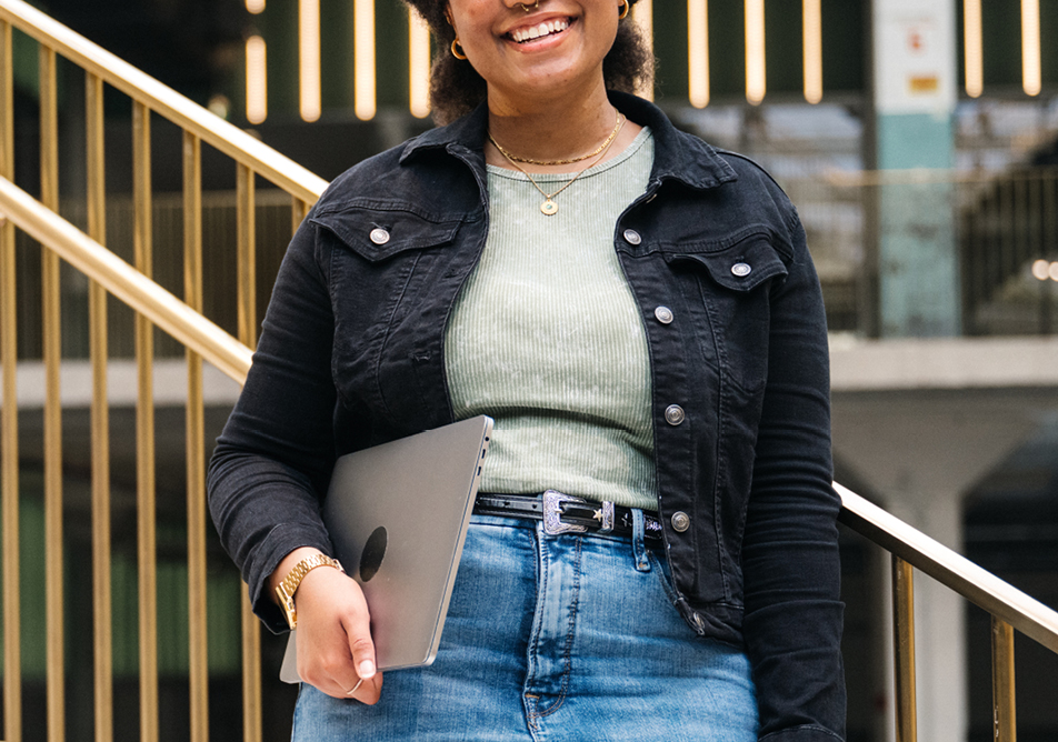 a person dressed casually and carrying a laptop