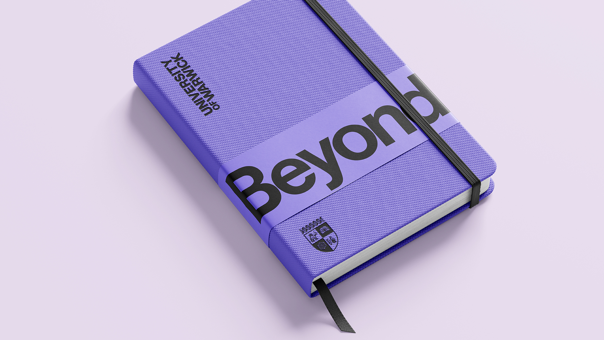 Purple notebook with word 'Beyond' and University of Warwick text and crest