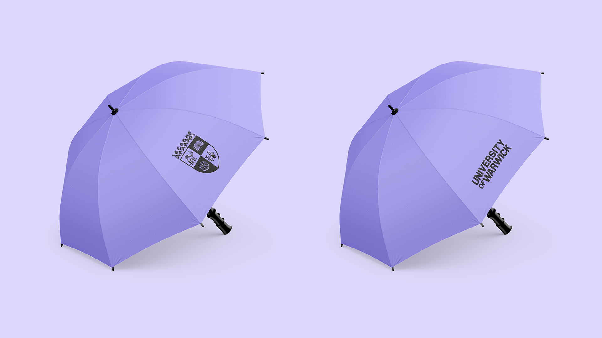Two purple umbrellas featuring University of Warwick text and crest on a light purple background