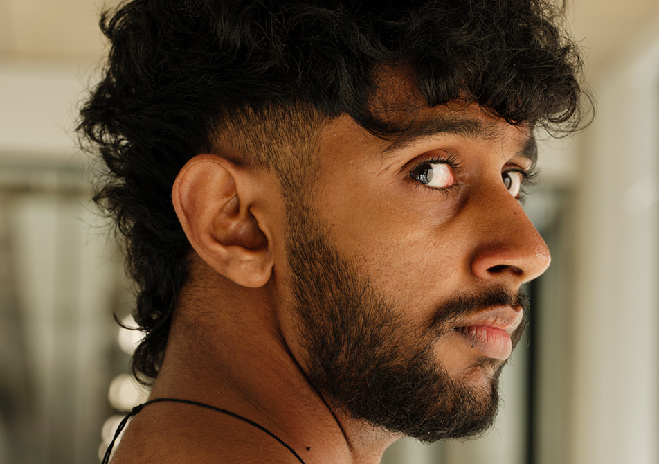A portrait of a person facing left which has been cropped in closer