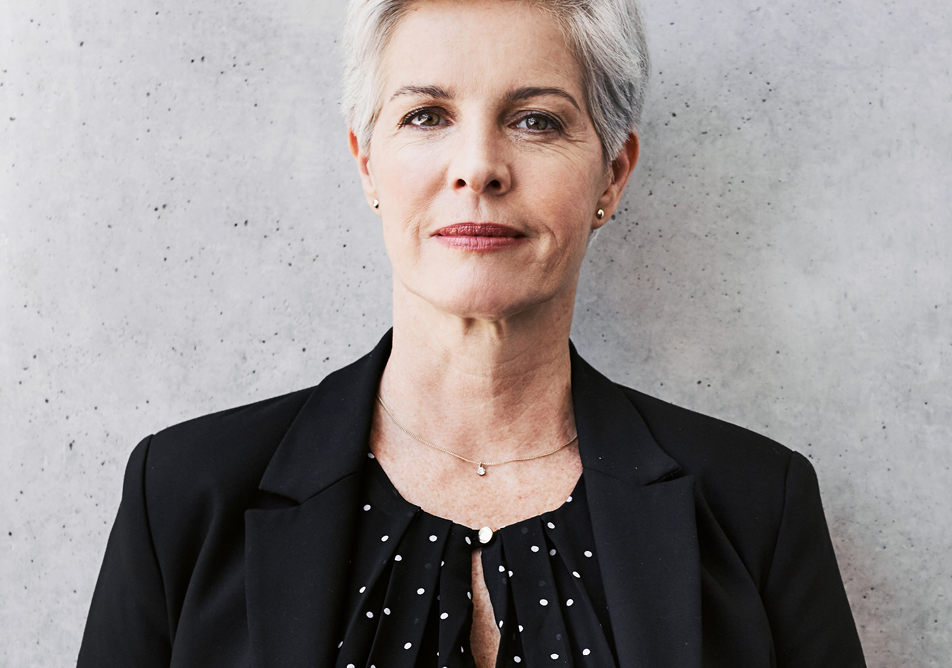 Portrait of a woman wearing a suit and facing the camera directly