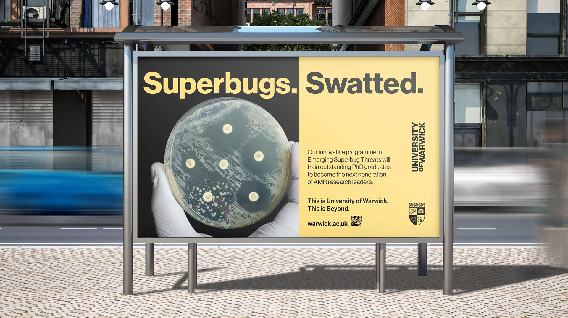 A yellow poster on the back of a bus stop displays an image of a white gloved hand holding a petri dish and the text "Superbugs. Superswatted."